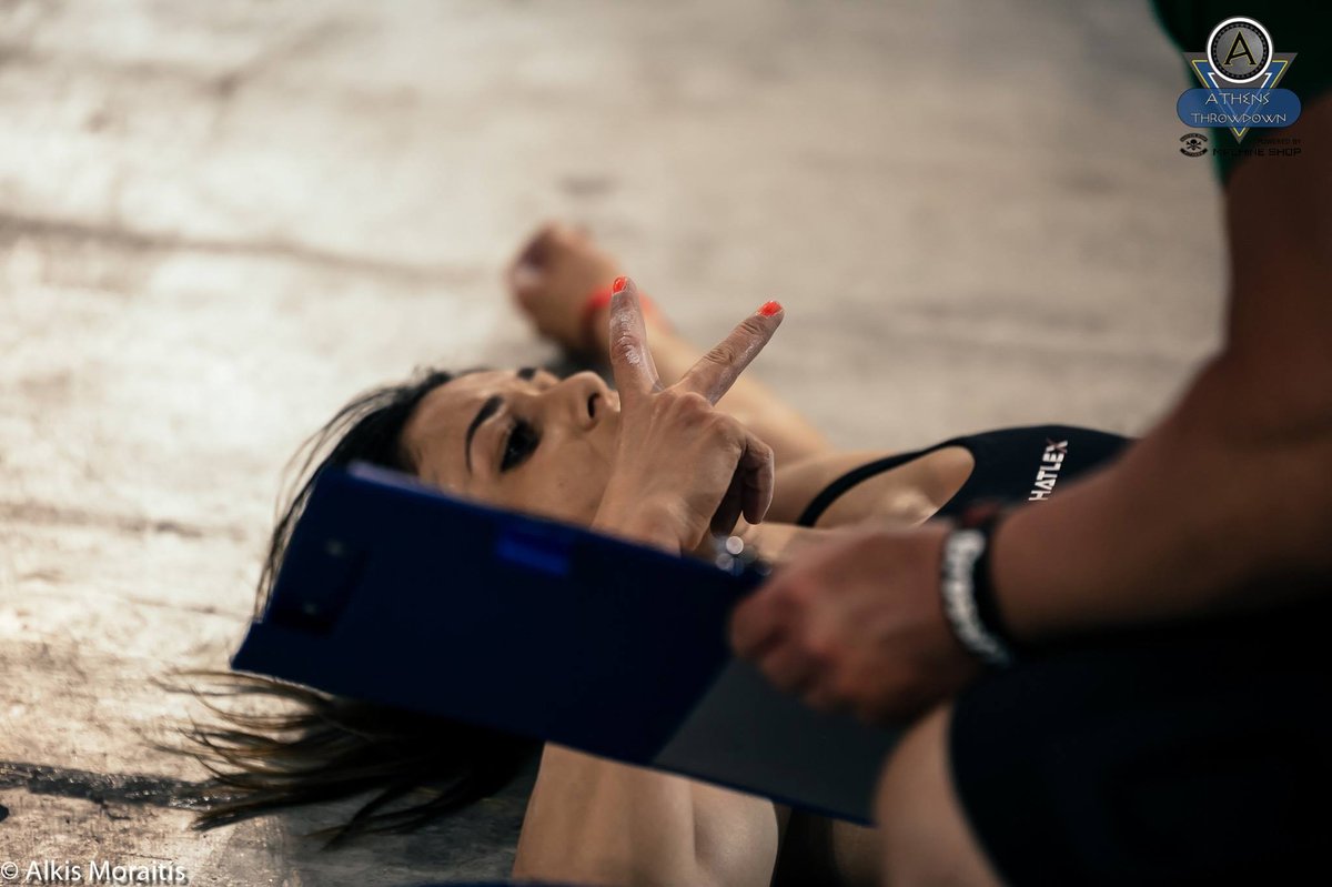 female athlete lying on the floor after workout