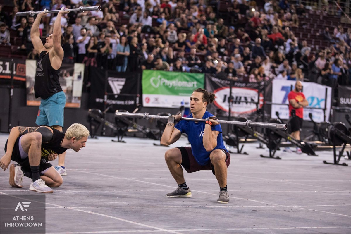 judge watching male athlete during workout