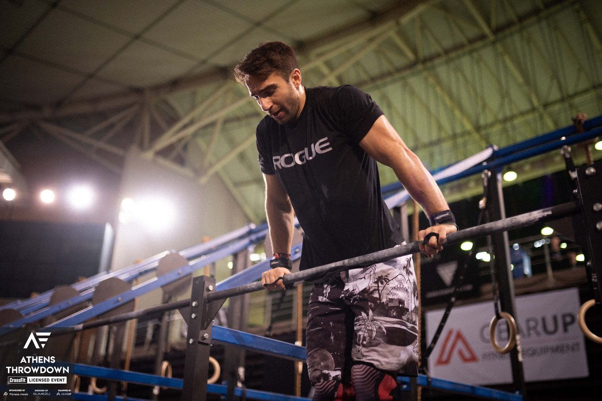Male athlete doing a bar muscle up during Athens Throwdown 2022 finals